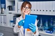 © Krakenimages.com - Young woman scientist smiling confident using touchpad at laboratory