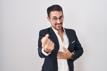 Wall Mural - Handsome business hispanic man standing over white background beckoning come here gesture with hand inviting welcoming happy and smiling