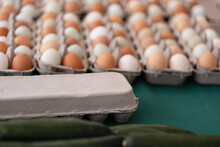 Brown, White, And Green Eggs From A Small Farm, Packaged Up And Ready For Sale At A Farmers Market.