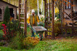 Leinwandbild Motiv seasonal autumn garden work. Woman gardener at wooden pergola with wheelbarrow. Natural country living
