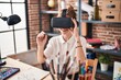© Krakenimages.com - Young blonde woman smiling confident using virtual reality glasses drawing at art studio