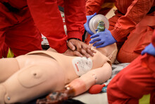 Paramedics Simulate Emergency Intervention On Medical Training Manikin
