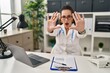 © Krakenimages.com - Young hispanic woman wearing doctor uniform and stethoscope doing stop gesture with hands palms, angry and frustration expression