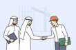 Handshake of arab businessmen and builder from architectural bureau standing near tower crane. Manager of international construction company makes important business deal with arab investors