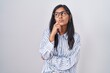 © Krakenimages.com - Young hispanic woman wearing glasses with hand on chin thinking about question, pensive expression. smiling with thoughtful face. doubt concept.