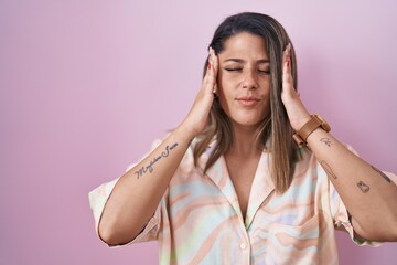 Sticker - Blonde woman standing over pink background with hand on head for pain in head because stress. suffering migraine.