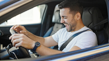 Poster - Young hispanic man smiling confident driving car at street