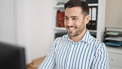 Wall Mural - Young hispanic man business worker using computer working at office