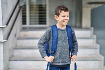 Wall Mural - Blond child student smiling confident standing at school