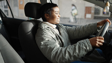 Sticker - African american woman smiling confident driving car at street