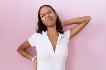 Poster - Young hispanic woman wearing casual white t shirt suffering of neck ache injury, touching neck with hand, muscular pain