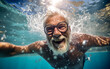 Elderly man swimming underwater. Happy elderly enjoying summer vacation