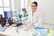 © Krakenimages.com - Young beautiful hispanic woman scientist smiling confident mixing sample at laboratory