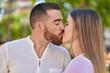 © Krakenimages.com - Man and woman couple hugging each other kissing at park