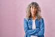 © Krakenimages.com - Middle age woman standing over pink background relaxed with serious expression on face. simple and natural looking at the camera.