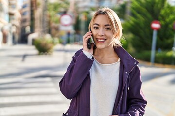 Poster - Young woman smiling confident talking on the smartphone at street