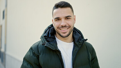 Sticker - Young hispanic man smiling confident standing at street