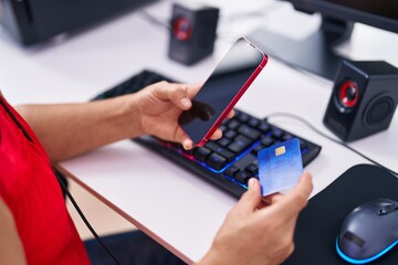 Poster - Middle age grey-haired woman streamer using credit card and smartphone at gaming room