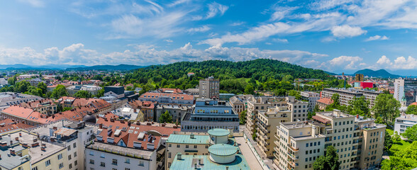 Wall Mural - A panorama view over rooftops towards Tivoli Park from central Ljubljana, Slovenia in summertime