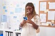 © Krakenimages.com - African american woman business worker smiling confident using smartphone at office