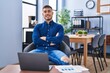 © Krakenimages.com - Young hispanic man business worker sitting with arms crossed gesture at office