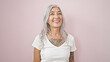 © Krakenimages.com - Middle age grey-haired woman smiling confident standing over isolated pink background