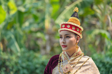 Wall Mural - Beautiful Laos girl dressed in ancient luxury national traditional Laos clothes costume. Asian young woman wearing antique traditional Laos Luang Prabang elegantly ethnic clothes culture.