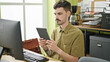 © Krakenimages.com - Young hispanic man business worker using computer and touchpad working at office