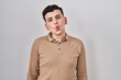 © Krakenimages.com - Non binary person standing over isolated background making fish face with lips, crazy and comical gesture. funny expression.