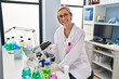 © Krakenimages.com - Young blonde woman scientist smiling confident using microscope at laboratory