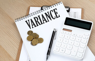 Wall Mural - VARIANCE text on a notebook with chart and calculator and coins, business concept