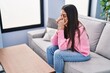 © Krakenimages.com - Young hispanic woman stressed sitting on sofa at home