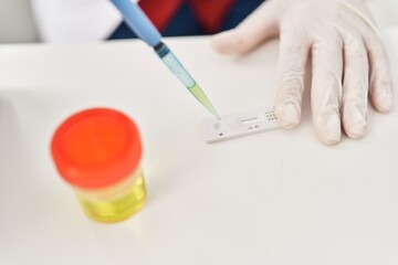 Wall Mural - Middle age hispanic woman doing urine test at laboratory