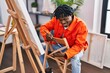 © Krakenimages.com - African american man artist smiling confident drawing at art studio