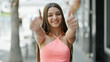 © Krakenimages.com - Young beautiful girl smiling confident doing ok sign with thumbs up at street