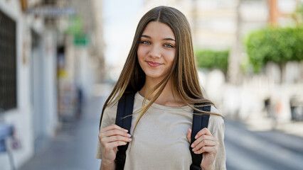 Canvas Print - Young beautiful girl student smiling confident wearing backpack at street