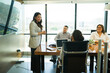 © AntonioDiaz - Businesswoman listening to a colleague during a presentation in office meeting room