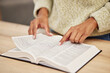 © Malik/peopleimages.com - Closeup, hands and woman with a bible, reading and religion for peace, guidance or personal growth. Zoom, female person or worship with scripture, learning or praise with gratitude, home or spiritual