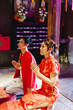 © topntp - Happy young Asian couple in Chinese traditional dresses praying at temple