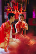 © topntp - Happy young Asian couple in Chinese traditional dresses praying at temple