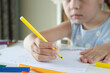 © lisssbetha - Cute child drawing a picture with colored felt-tip pens. Concept of education