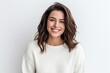 © Hanne Bauer - Medium shot portrait photography of a grinning woman in her 30s wearing a cozy sweater against a white background