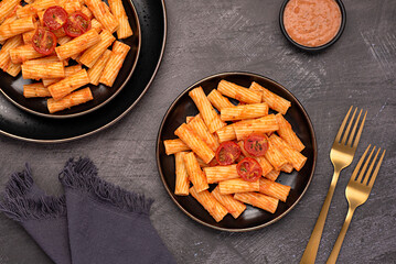 Wall Mural - Food photography of pasta, rigatoni with  roasted tomatoes, sauce, olive oil, durum, wheat, semolina, fork, background, italian