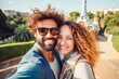 © Nataliia - Travel couple happy making selfie portrait with smartphone in Park Guell, Barcelona, Spain. Generative Ai content