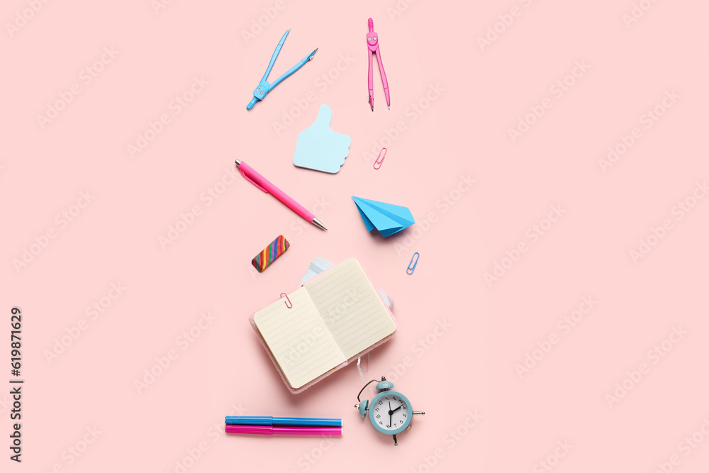 Composition with blank notebook and stationery supplies on pink background