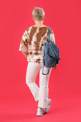 Poster - Female student with backpack on red background, back view