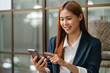 © mojo_cp - Business people using smart phone while working  in office..