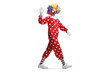 © Ljupco Smokovski - Full length shot of a clown in red costume walking and waving