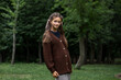 © Andrey_Arkusha - Beautiful teenage girl in a knitted brown sweater in summer park