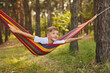 © Inna Vlasova - Cute little blond caucasian boy having fun with multicolored hammock
